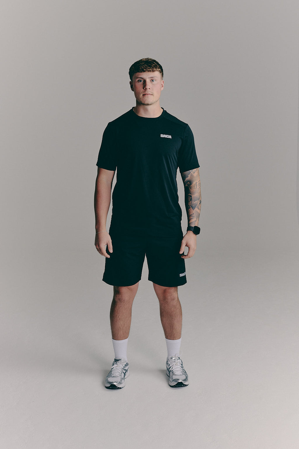 SACA Essential Tee in black — front view worn by model