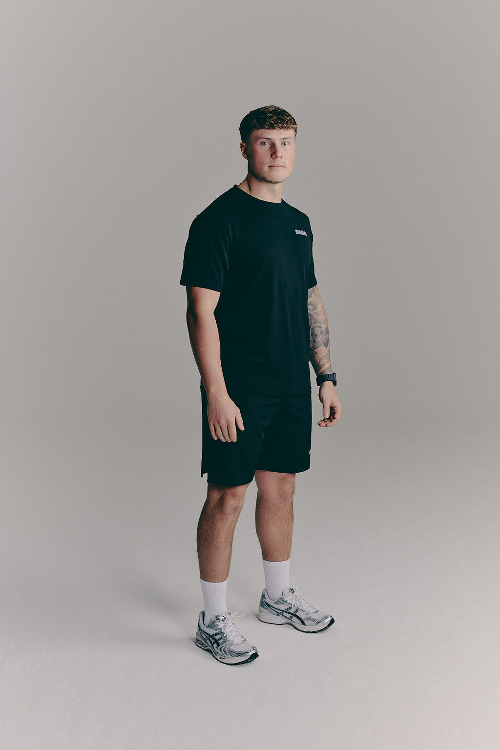 SACA Essential Tee in black — detail of SACA branding