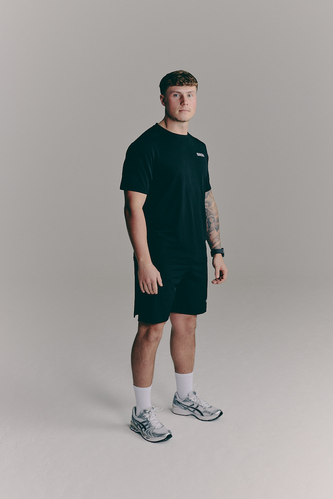 SACA Essential Tee in black — detail of SACA branding