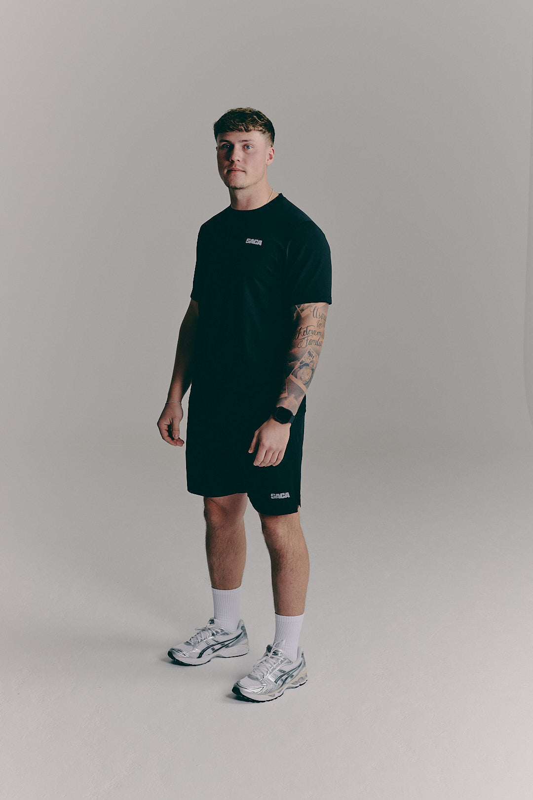 SACA Essential Tee in black — back view worn by model