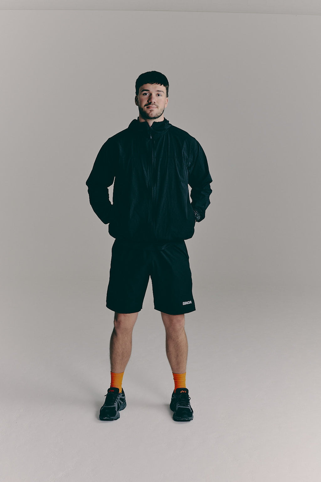 SACA Flux Windbreaker in black — front view worn by model