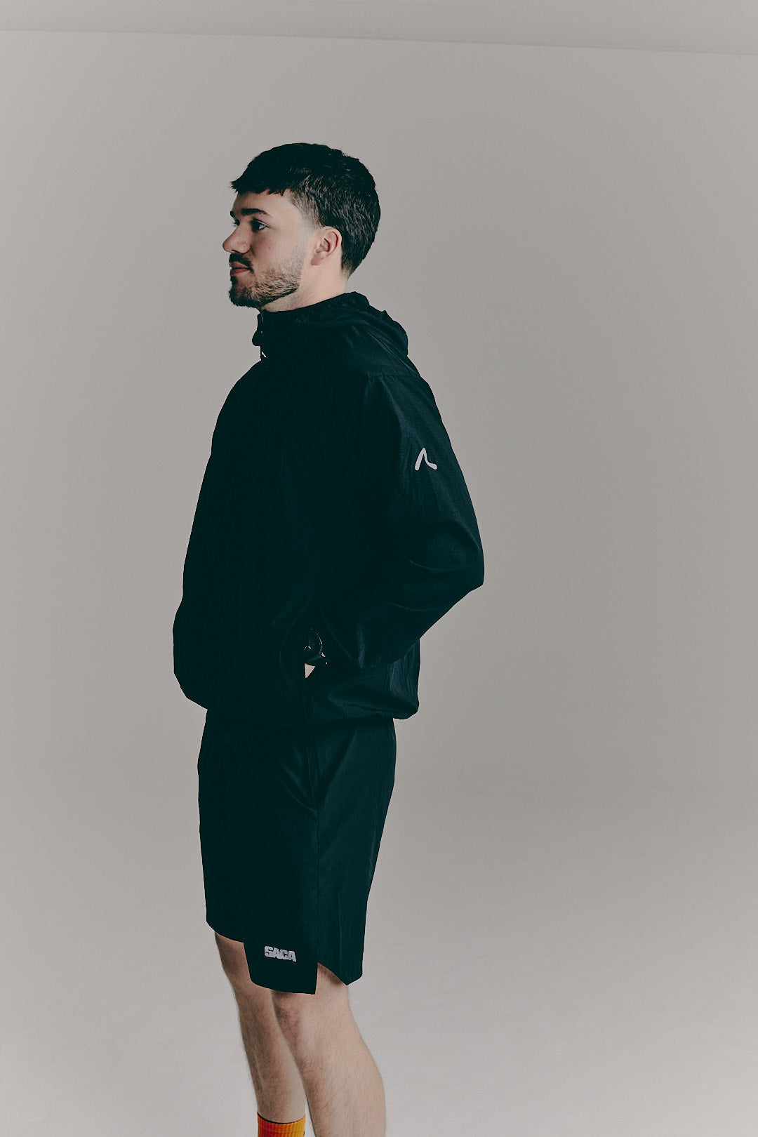 SACA Flux Windbreaker in black — side view worn by model