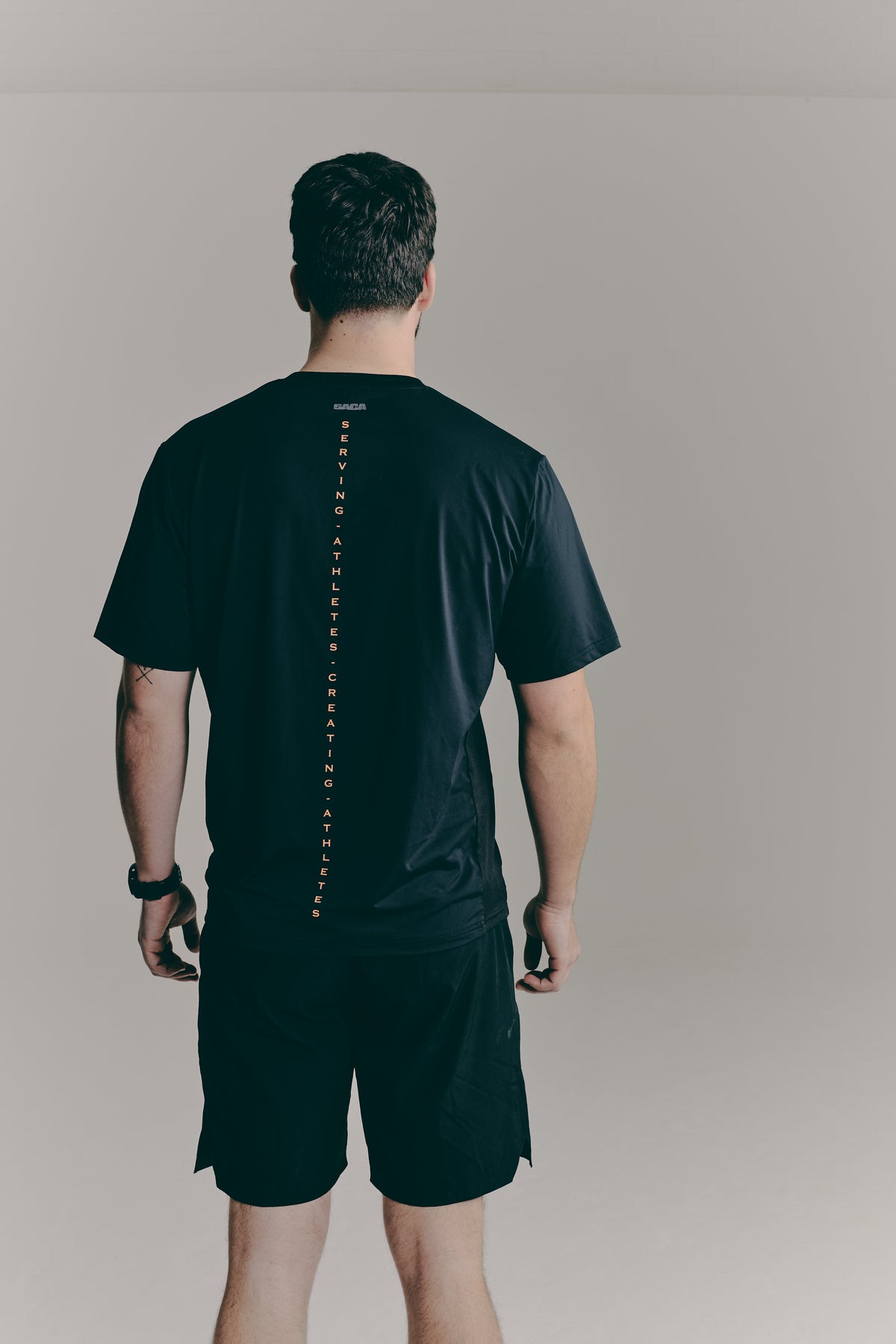 SACA Contest T-Shirt in black — back view worn by model
