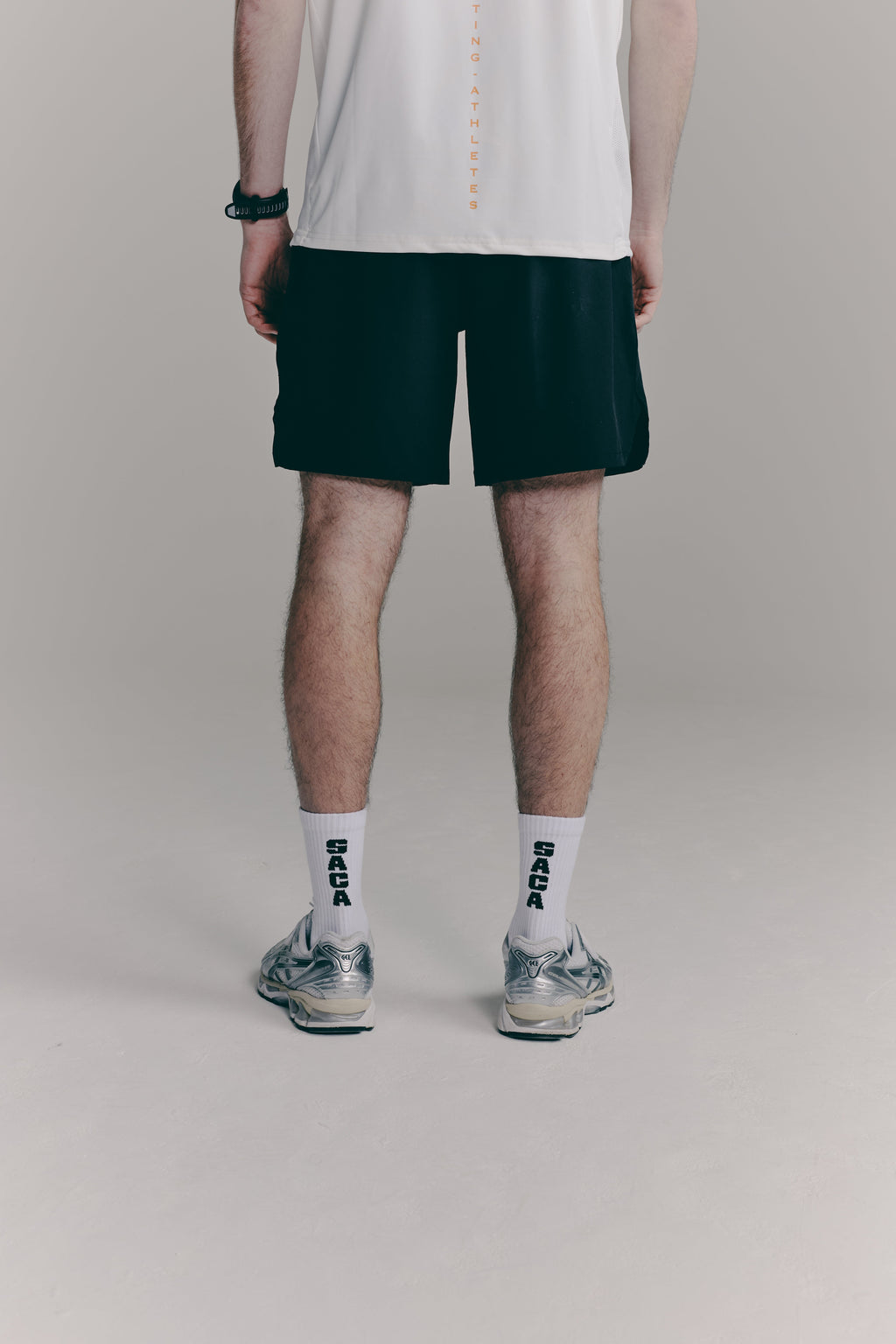 SACA Contest Shorts in black — side view worn by model