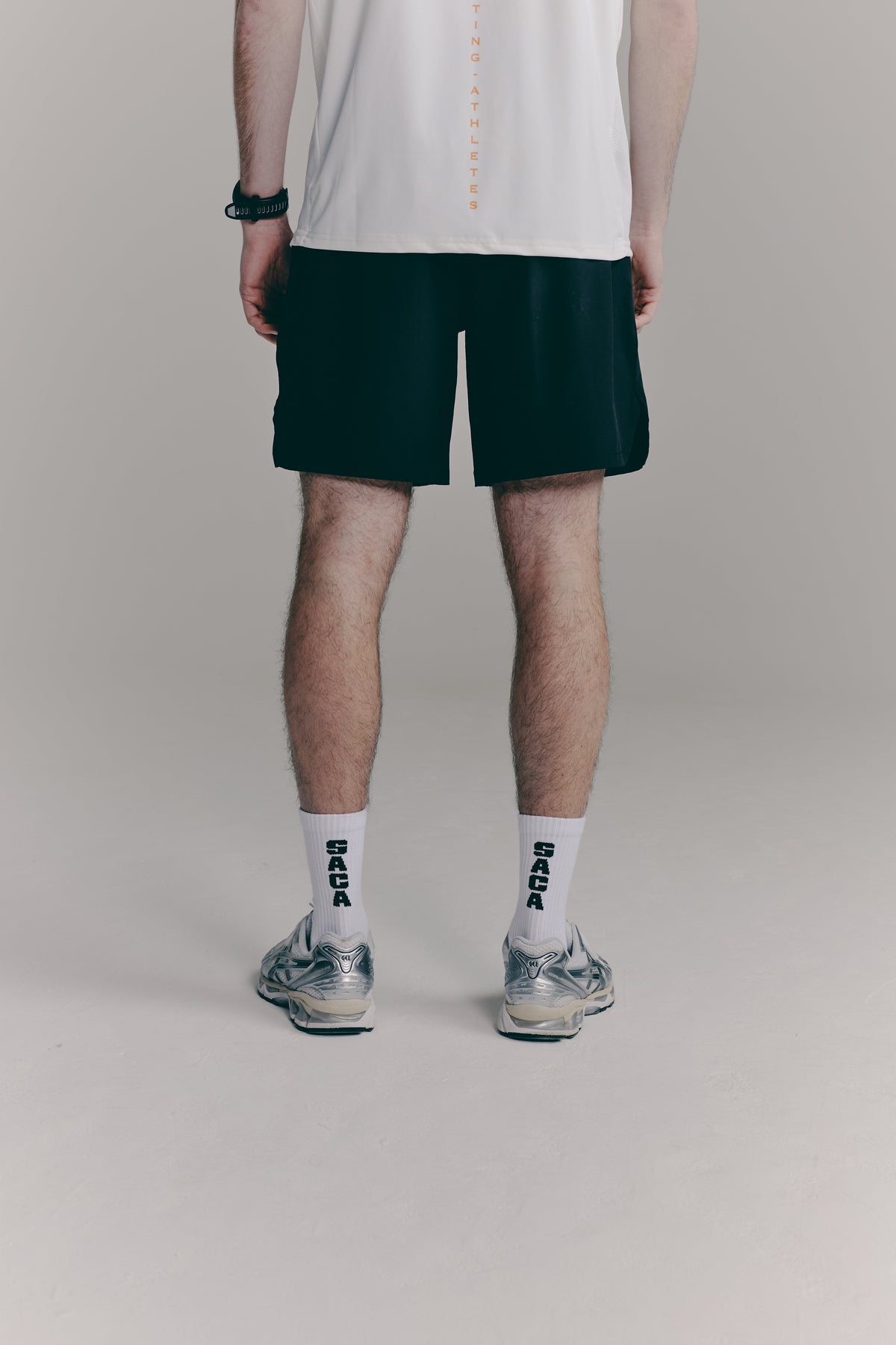 SACA Contest Shorts in black — side view worn by model