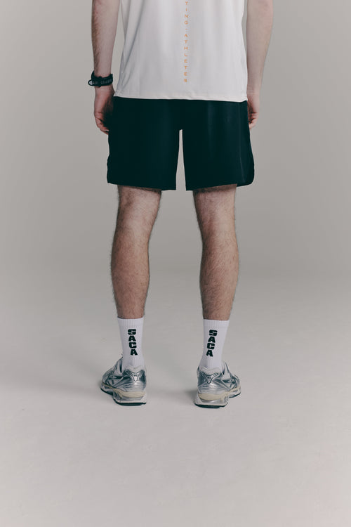 SACA Contest Shorts in black — side view worn by model