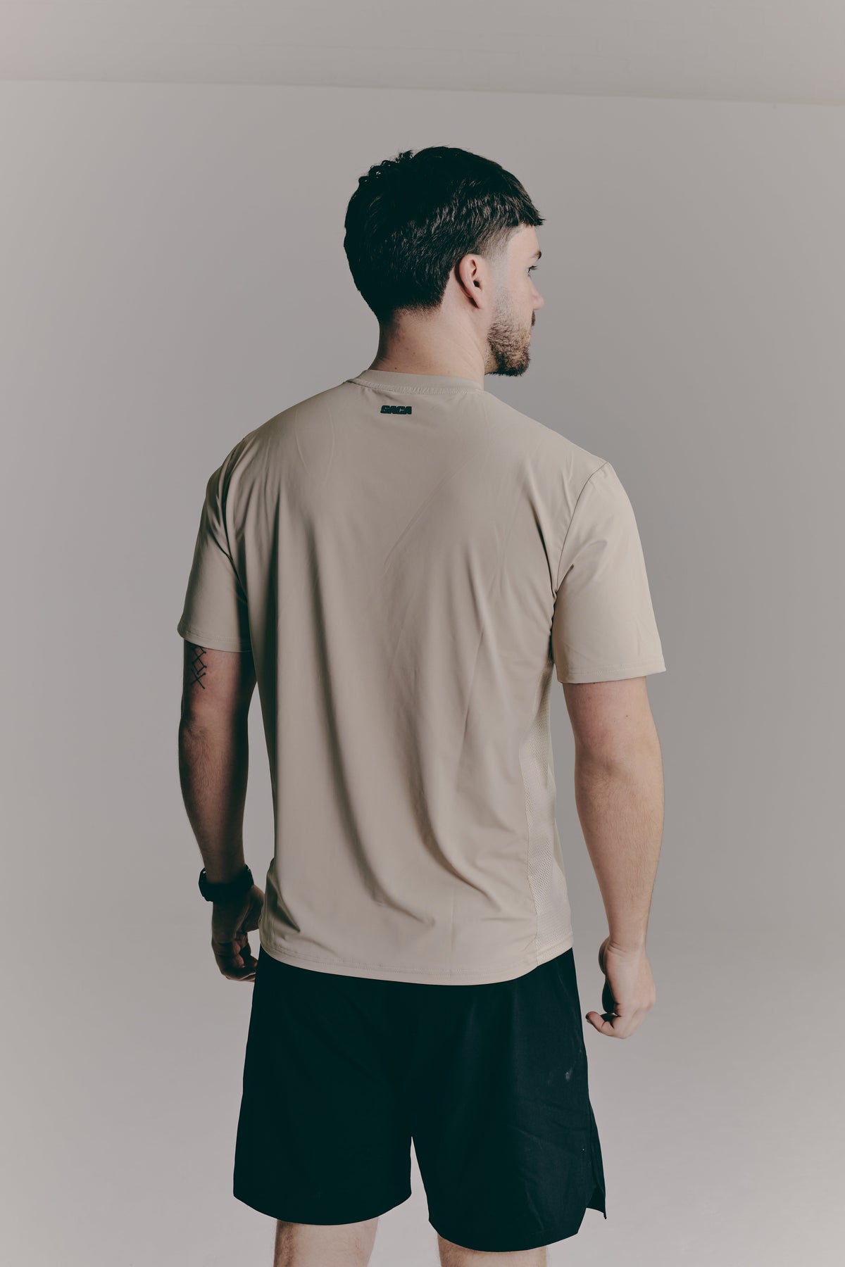 SACA Contest T-Shirt in beige — side view worn by model