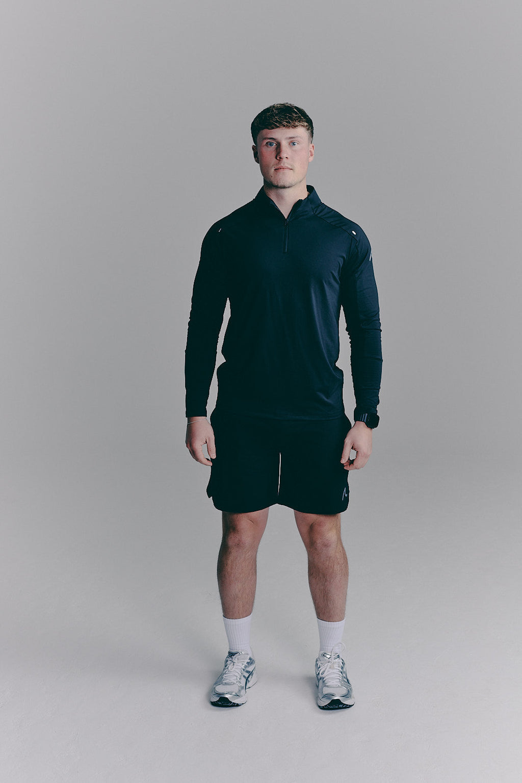 SACA Velo Quarter Zip in black — front view worn by model
