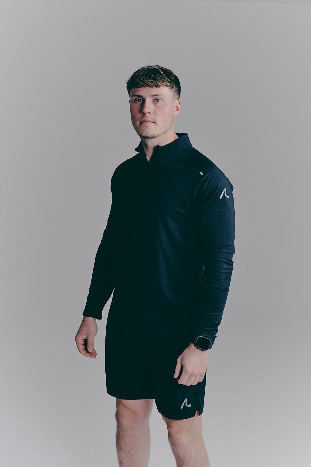 SACA Velo Quarter Zip in black — side view worn by model
